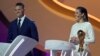 FILE - Former American soccer international Carli Lloyd, right, and Jermaine Jenas, English television presenter, pundit and retired professional soccer player assist with the 2022 soccer World Cup draw at the Doha Exhibition and Convention Center in Doha, Qatar, April 1, 2022.