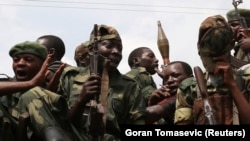 FILE: M-23 rebel fighters ride in a truck as they withdraw from Goma December 1, 2012.