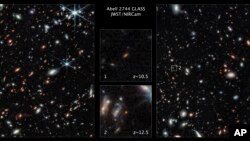 This image made available by the Space Telescope Science Institute Nov. 17, 2022, shows two of the galaxies captured by the James Webb Space Telescope in the outer regions of the giant galaxy cluster Abell 2744. (NASA; ESA; CSA; Tommaso Treu, UCLA; Zolt G. Levay, STScI, via AP)