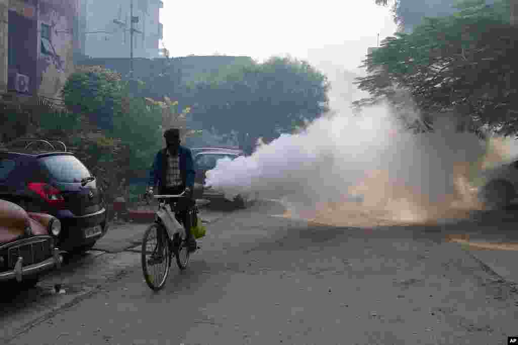 A municipal worker fumigates an area to prevent the spread of mosquito-borne diseases in Prayagraj, in the northern state of Uttar Pradesh, India.