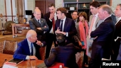 U.S. President Joe Biden, left, talks with world leaders about the missile strike on Poland at the G-20 Leaders' Summit, in Nusa Dua, Bali, Indonesia, Nov. 16, 2022, in this handout photo taken by German government speaker Steffen Hebestreit.