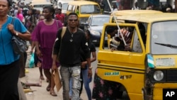 People walk during rush hours in Lagos, Nigeria, Nov. 14, 2022. The world's population hit an estimated 8 billion on Nov. 15, 2022, according to the United Nations Population Fund.