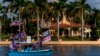 A boat with supporters flying flags for former President Donald Trump is anchored outside of his club, Mar-a-lago in Palm Beach, Nov. 15, 2022. 