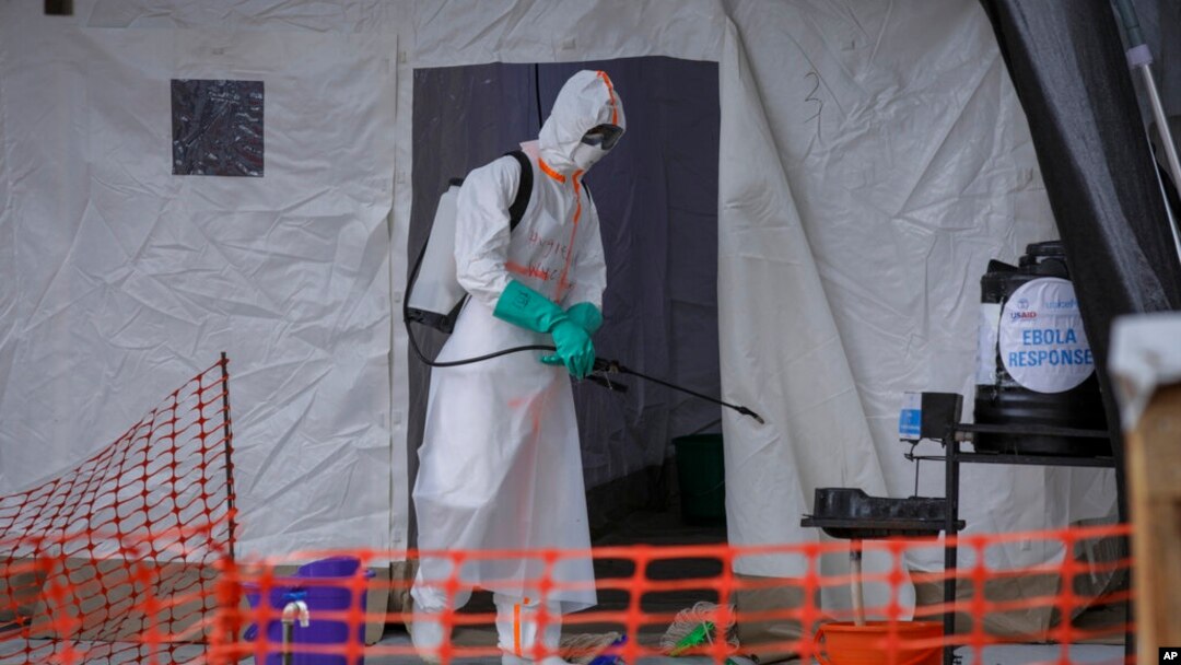FILE - A medical worker disinfects a tent used for suspected Ebola victims inside the Ebola isolation center of Madudu Health Center III, in the village of Madudu, in the Mubende district of Uganda, Nov. 1, 2022. 