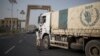 FILE - A convoy of aid trucks to Ethiopia's Tigray region leaves the outskirts of Semera, Afar region, Ethiopia, on May 15, 2022.