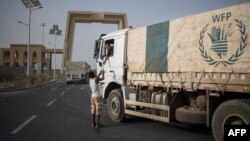 FILE - A convoy of aid trucks to Ethiopia's Tigray region leaves the outskirts of Semera, Afar region, Ethiopia, on May 15, 2022.