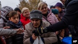 People receive food donations from World Central Kitchen in Kherson, in southern Ukraine, on Nov. 17, 2022.