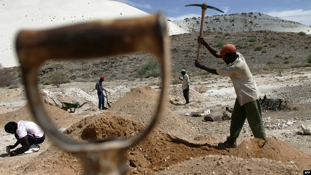 FILE - Workers try to start up an old metals mine in Uis, Namibia. Mining is the biggest contributor to Namibia’s gross domestic product.