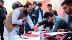 Taliban prisoners are checked with documents as they are released from Pul-e-Charkhi jail in Kabul, Afghanistan, Aug. 13, 2020. 