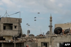 FILE— Aid parcels are airdropped over the northern Gaza Strip on March 8, 2024.