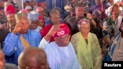 Nigeria's new president-elect, Bola Tinubu gestures at people around him, after he was declared winner in the West African nation's presidential race, Abuja, March 1, 2023.