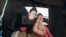 FILE - Renu, eldest sister of Shamima Begum, who had gone missing at the time, holds up a picture of her while being interviewed by the media in London, Britain, Feb. 22, 2015.