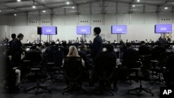Delegates gather for a meeting with the COP27 presidency that was closed to the press, at the U.N. Climate Summit, in Sharm el-Sheikh, Egypt, Nov. 19, 2022. 