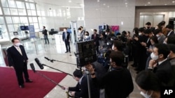 South Korean President Yoon Suk Yeol answers reporters' questions upon his arrival at the presidential office in Seoul, Nov. 18, 2022. Yoon has suspended his routine morning Q&A sessions with journalists.
