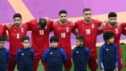 Iran players listen to the national anthem ahead of the Qatar 2022 World Cup Group B football match between England and Iran at the Khalifa International Stadium in Doha, Nov. 21, 2022. 
