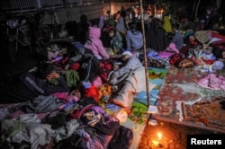 Locals are sheltered outside their houses after earthquake hit in Cianjur, West Java province, Indonesia, Nov. 21, 2022. (Antara Foto/Raisan Al Farisi/via Reuters)