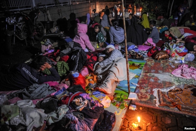 Locals are sheltered outside their houses after earthquake hit in Cianjur, West Java province, Indonesia, Nov. 21, 2022. (Antara Foto/Raisan Al Farisi/via Reuters)
