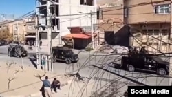 A screengrab of a UGC video posted on social media Nov. 20, 2022, purports to show security forces driving through the streets of Mahabad, amid anti-government protests in the country's Kurdish region.