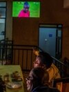 FILE - Members of AS Kigali women’s football club watch a soccer match of Africa Cup of Nations between Zimbabwe and Guinea, officiated by their head coach and centre referee Salima Mukansanga in Kigali, Rwanda January 18, 2022.