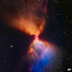 This image made available by the Space Telescope Science Institute on Wednesday, Nov. 16, 2022, shows a protostar within the dark cloud L1527 embedded within a cloud of material feeding its growth, captured by the James Webb Space Telescope. (NASA, ESA, CSA, STScI, Joseph DePasquale (STScI), Alyssa Pagan (STScI), Anton M. Koekemoer (STScI) via AP)