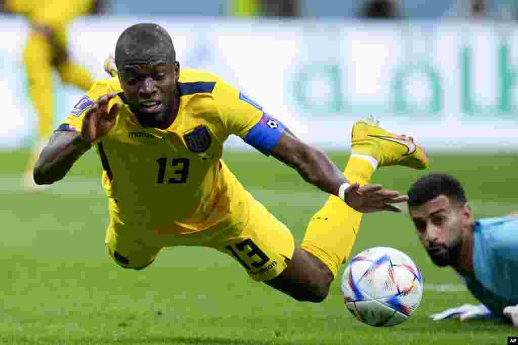 Ecuador&#39;s Enner Valencia falls, fouled by Qatar&#39;s goalkeeper Saad Al Sheeb, during a World Cup group A soccer match at the Al Bayt Stadium in Al Khor, Qatar.