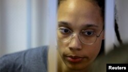 FILE - US basketball player Brittney Griner looks on inside a defendants' cage before a court hearing in Khimki outside Moscow, Aug. 4, 2022.