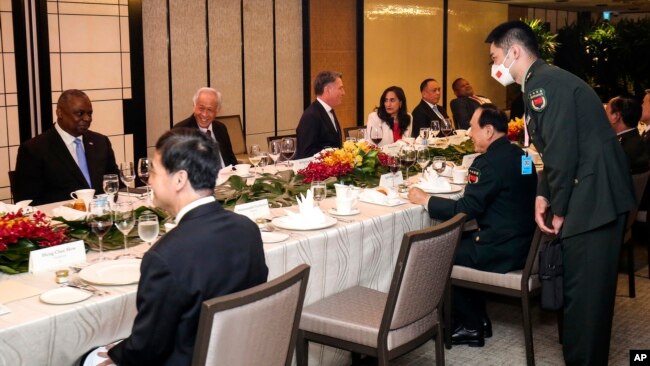 FILE - China's Defense Minister Gen. Wei Fenghe, center right, talks with U.S. Secretary of Defense Lloyd Austin, left, during the 19th International Institute for Strategic Studies (IISS) Shangri-la Dialogue, Asia's premier defense forum, in Singapore, J