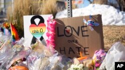 FILE - Bouquets of flowers sit on a corner near Club Q, the site of a mass shooting the day before in Colorado Springs, Colo., on Nov. 21, 2022.