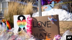 Bouquets of flowers sit on a corner near Club Q, the site of a mass shooting the day before in Colorado Springs, Colo., on Nov. 21, 2022.