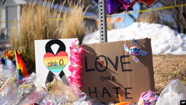 Bouquets of flowers sit on a corner near Club Q, the site of a mass shooting the day before in Colorado Springs, Colo., on Nov. 21, 2022.