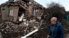 A woman walks past her house, severely damaged by Russian shelling, in Kramatorsk, Ukraine, Nov. 19, 2022.