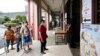 Voters wait in a line to cast their ballots for general election at a polling station in Kuala Lumpur, Malaysia, Nov. 19, 2022. 