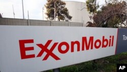 FILE - The sign for the Exxon Mobil Torrance Refinery in Torrance, Calif., Jan. 30, 2012. An explosion and fire at an oil refinery in Torrance, California, on Saturday forced the partial shutdown of the plant, leading oil traders to expect a spike this we