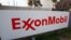 FILE - The sign for the Exxon Mobil Torrance Refinery in Torrance, Calif., Jan. 30, 2012. On Wednesday, Exxon Mobil shareholders pushed the company to share more information about whether regulations designed to reduce climate change will hurt the oil giant's business.