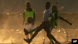 Children play soccer in June 2021 in the dirt east of Johannesburg in South Africa. FIFA says its Football for Schools program is more important for the game of soccer than the upcoming World Cup. (AP)