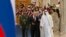 Russian President Vladimir Putin, foreground left, and Abu Dhabi Crown Prince Mohamed bin Zayed al-Nahyan, right, are seen at the official welcoming ceremony for Putin, in Abu Dhabi, United Arab Emirates, Oct. 15, 2019.
