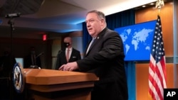 FILE - Secretary of State Mike Pompeo arrives for a media briefing, Nov. 10, 2020, at the State Department in Washington.