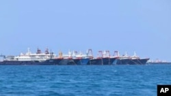 Some of the 220 Chinese vessels are seen moored at Whitsun Reef, South China Sea, March 7, 2021. (Philippine Coast Guard/National Task Force-West Philippine Sea via AP)