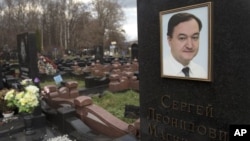 caption: A tombstone on the grave of lawyer Sergei Magnitsky, who died in jail, at a cemetery in Moscow, November 16, 2012.