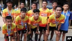 FILE - Members of the Wild Boars soccer team who were rescued from a flooded cave, pose for the media after a marathon and biking event in Mae Sai, Chiang Rai province, Thailand, June 23, 2019. (AP Photo/Sakchai Lalit)