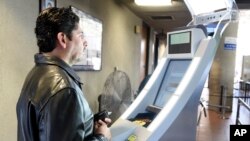 A pedestrian crossing from Mexico into the United States at the Otay Mesa Port of Entry has his facial features and eyes scanned at a biometric kiosk in San Diego, California, Dec. 10, 2015. Senior U.S. administration officials have shed more light on the K-1 visa application process, which has come under scrutiny following this month’s mass shooting in San Bernardino, California.