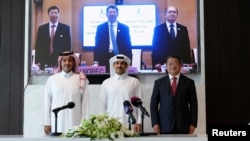 QatarEnergy CEO and Qatar's Minister of Energy Saad al-Kaabi, bottom row center, stands at a signing ceremony with Sinopec, in Doha, Qatar, Nov. 21, 2022.