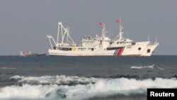 FILE - Chinese Coast Guard vessels are pictured in the South China Sea off the Philippines, April 5, 2017.