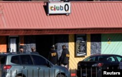 FILE - FBI agents stand outside the Club Q, an LGBTQ nightclub, the day after a mass shooting in Colorado Springs, Colorado, Nov. 21, 2022.