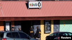 FBI agents stand outside the Club Q, an LGBTQ nightclub, the day after a mass shooting in Colorado Springs, Colo., Nov. 21, 2022.