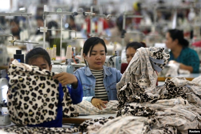 FILE - Employees work at a garment factory in Kandal province, Cambodia, Dec. 12, 2018.