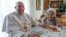 In this image made available by Vatican Media, Pope Francis sits for lunch in the home of a cousin, Carla Rabezzana, in the town of Portacomaro, about 10 kilometers east of Asti, northern Italy, Nov. 19, 2022.