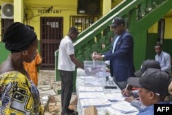 Voters register to vote at the Nuestra Senior college polling station in Bisila, Malabo during Equatorial Guinea's presidential, legislative and municipal elections on November 20, 2022.