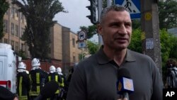 FILE - Kyiv mayor Vitali Klitschko speaks to the press at the scene of a residential building following explosions, in Kyiv, June 26, 2022.