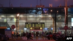 People wait outside the closed Jorge Chavez International Airport after the accident of the LA2213 flight in Lima, on Nov. 18, 2022.